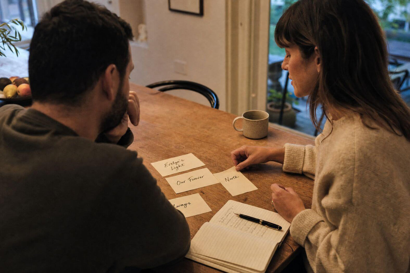 Two people brainstorming meaningful star name ideas at a table